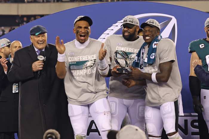 Eagles from left to right, Jalen Hurts, Fletcher Cox, and A.J. Brown celebrate winning NFC title